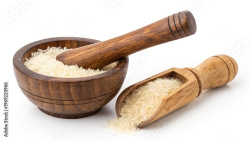 Wooden bowl filled with rice and a wooden scoop. A natural and rustic aesthetic, with the focus on the grains