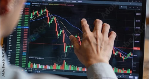 Analyst examining financial data on computer screen