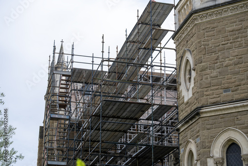 Φωτογραφία Scaffolding installed around a historic stone church in Melbourne, Australia, indicating restoration and maintenance work