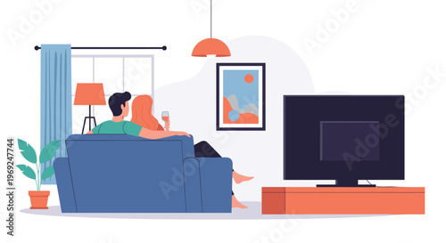 Happy couple sitting on a blue sofa and watching a large television in a modern and cozy living room interior during evening.