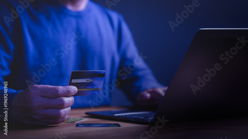 Person using credit card for online shopping and digital payment on laptop. Secure e-commerce finance, banking, and business transaction concept for internet security.