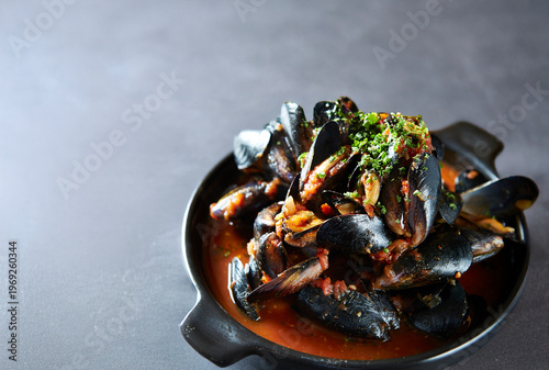 Tomato mussel soup in a pot