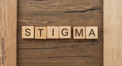 Word stigma spelled out with wooden blocks placed creatively on rustic wooden background with shapes