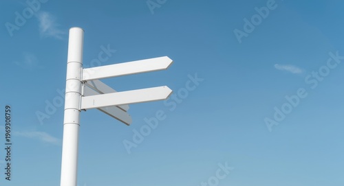 White pylon signposts with clear sky backdrop optimized for text addition