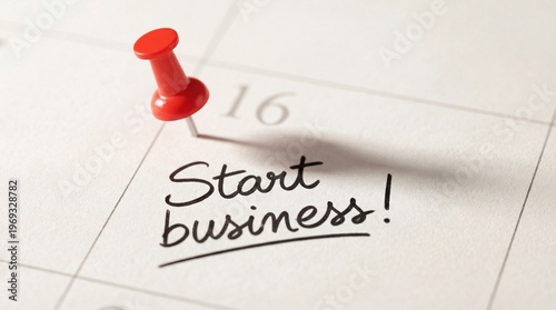 Red pushpin on a calendar date 16 with the handwritten text start business