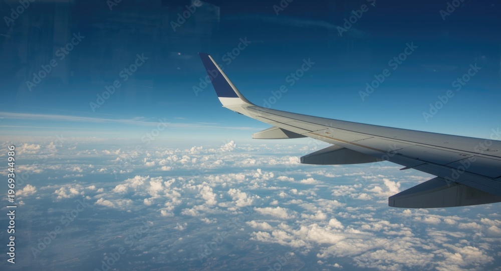 Fototapeta premium Looking outside an airplane window to see the wing in motion