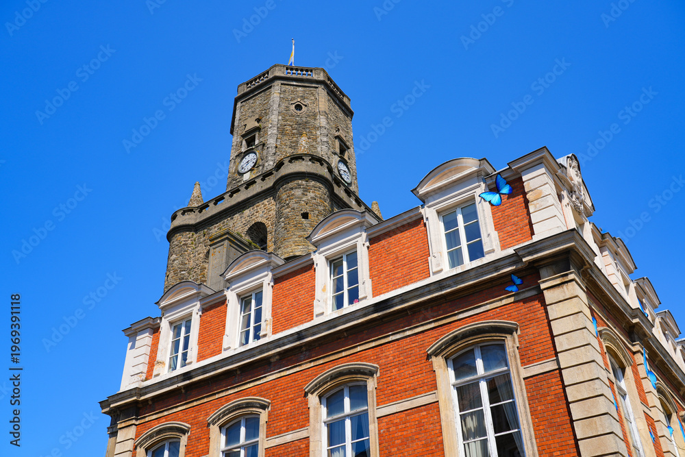 Fototapeta premium The medieval belfry and the decorated City Hall in the old town of Boulogne-sur-Mer in Pas-de-Calais, Northern France