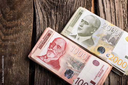Setrbian Dinar banknote on a wooden background. Top view. No people.