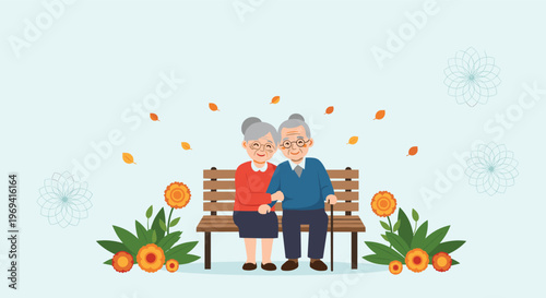 Happy senior couple sitting together on a park bench during the autumn season surrounded by falling leaves and flowers for love.