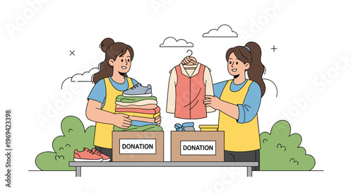 Two female volunteers in yellow vests sorting and packing clothes into cardboard boxes marked for donation in an outdoor setting.