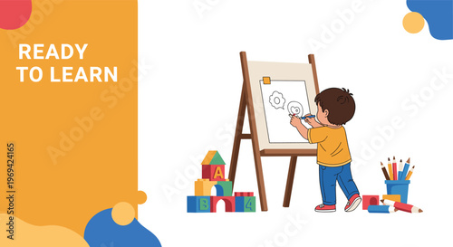 Young boy standing at an easel painting a picture on a white canvas with various toys and art supplies on the floor around him.