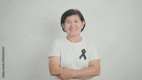 Elderly with Black ribbon for May Melanoma and skin cancer Awareness month, October Vaccine injury awareness month, Mourning Remembrance, March Sleep awareness week, Gang Prevention and Anti Violence