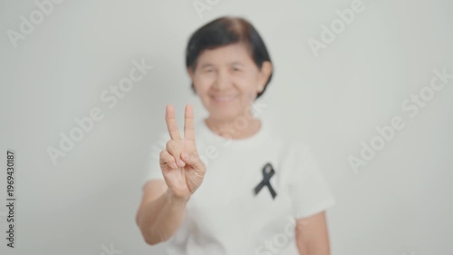 Elderly with Black ribbon for May Melanoma and skin cancer Awareness month, October Vaccine injury awareness month, Mourning Remembrance, March Sleep awareness week, Gang Prevention and Anti Violence