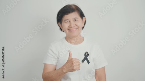 Elderly with Black ribbon for May Melanoma and skin cancer Awareness month, October Vaccine injury awareness month, Mourning Remembrance, March Sleep awareness week, Gang Prevention and Anti Violence