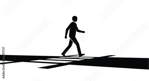 Silhouette of a person walking across a stark white crosswalk with dramatic shadows.