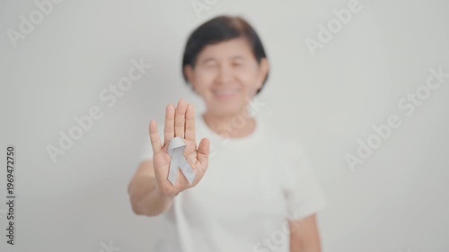 Elderly with Gray ribbon for May Brain Cancer Awareness month and Asthma Awareness, Support life people Survivor. Healthcare and February World cancer day