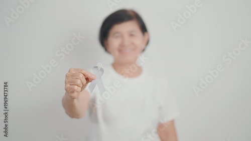 Elderly with Gray ribbon for May Brain Cancer Awareness month and Asthma Awareness, Support life people Survivor. Healthcare and February World cancer day