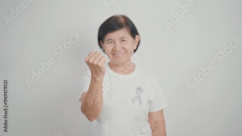 Elderly with Gray ribbon for May Brain Cancer Awareness month and Asthma Awareness, Support life people Survivor. Healthcare and February World cancer day