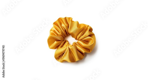 Luxurious yellow satin scrunchie hair accessory seen from above on white background