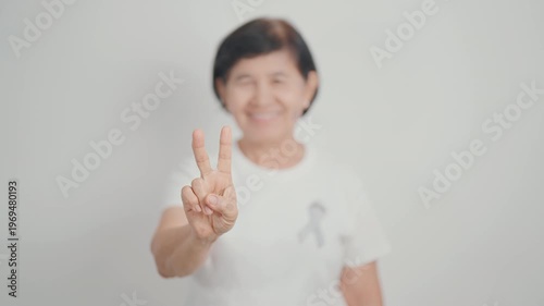 Elderly with Gray ribbon for May Brain Cancer Awareness month and Asthma Awareness, Support life people Survivor. Healthcare and February World cancer day