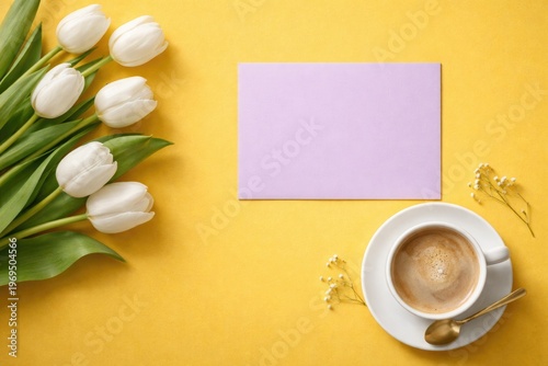 Copy space background with yellow surface white tulips coffee cup and purple card top view