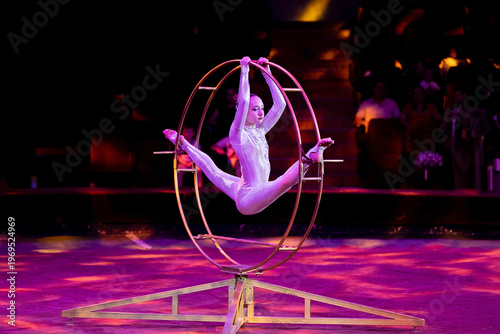 Картината върху платно A teenage girl performs an acrobatic act on a circus ring