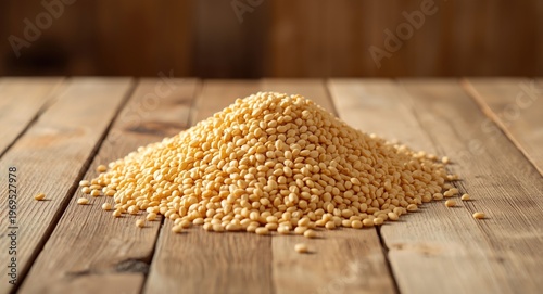 Natural wood table covered with a mound of milled corn grains for porridge and flakes
