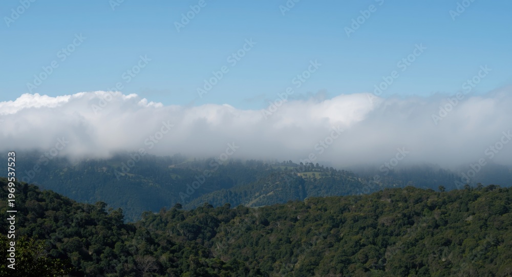 Obraz premium Natural terrain hidden beneath smoke and low cumulus cloud cover