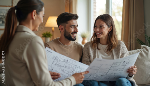 Real estate agent consults happy couple reviewing house blueprints. Young family discusses new home options with property advisor. Planning future investment, choosing floor plan.