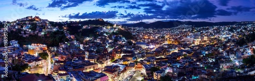 Panoramic view of the colorful cityscape of Guanajuato, Mexico at night