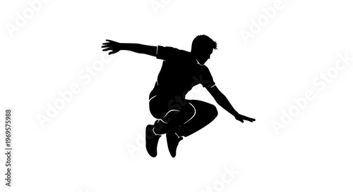 Silhouette of a person performing a parkour jump with free running