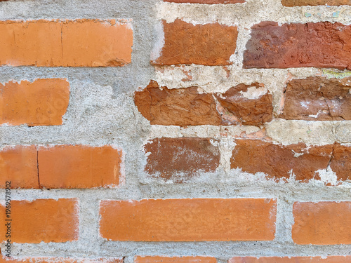 Rough texture background of red brickwork with signs of destruction and wear. Full frame. Close-up