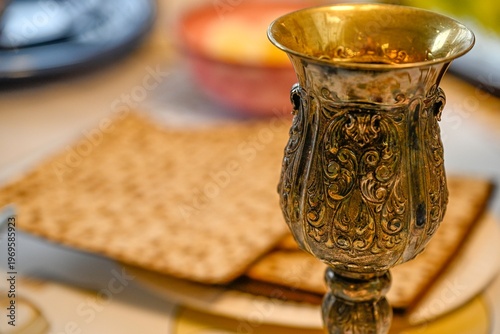 Traditional Passover Seder table set for Jewish holiday celebration in Israel, featuring festive dinner setup, symbolic foods, wine glasses, and family gathering atmosphere for Pesach evening.