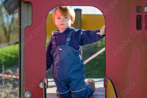 Toddler Standing In Playground Structure