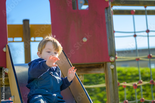 Toddler Sliding Down Playground Slide
