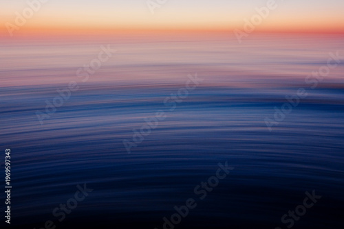 Abstract blue ocean motion blur with flowing wave patterns