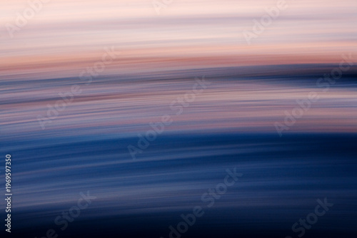 Soft abstract ocean blur with pastel sunset tones