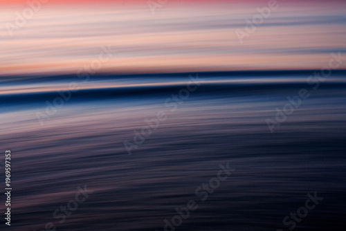 Abstract ocean motion blur at sunset with soft pastel tones