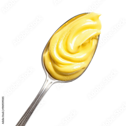 A spoonful of creamy yellow mayonnaise on a black background