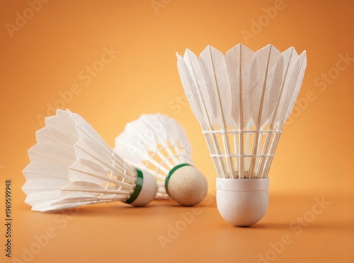 Close-Up of White Shuttlecocks on Orange Background for Badminton Sports and Training Equipment