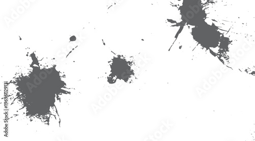 Dark grey ink splatters and paint drips on a plain white background