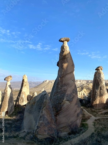 Fotografía Cappadocia fairy chimneys rock formations under blue sky in Turkey iconic landsc