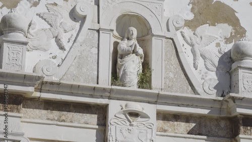 Detailed view of a religious figure on the Igreja da Misericórdia facade.