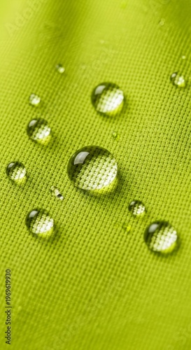 Water droplets on green fabric surface.