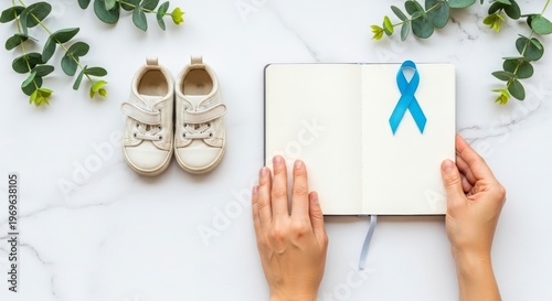 Baby boy announcement with blue ribbon.