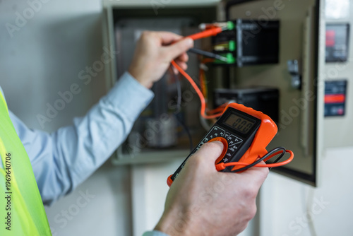 hand electrician check main power load center distribution board. circuit breaker cable wiring.