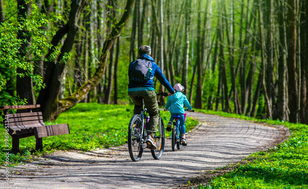 Naklejka premium Cyclists ride on the bike path in the city Park 