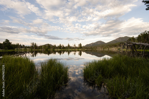 Mountains and clouds reflecting in tranquil Rocky Mountain lake