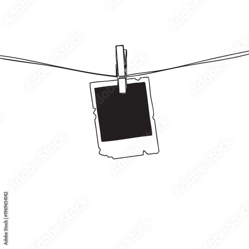 A single instant photograph hangs from a line creating a striking visual silhouette high quality professional