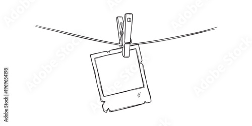 A simple sketch depicts a photograph hanging on a clothesline using a wooden clip silhouette